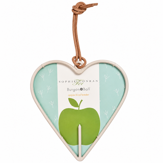 Sophie Conran For Burgon Ball apple bird feeder, featuring a heart-shaped frame with a light green and white background, a green apple illustration, and a brown leather hanging loop.