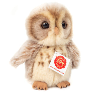 Stuffed owl toy with a Hermann Teddy Collection tag on a white background
