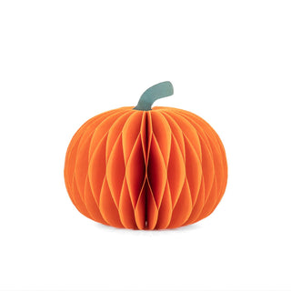 An orange honeycomb paper pumpkin decoration with a small green stem, shown on a plain white background.