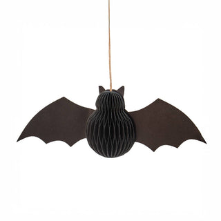 A black bat-shaped hanging decoration made of layered honeycomb material, suspended by a thin string against a plain white background.