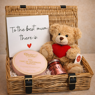 Gift basket with teddy bear, truffles, and scented candle on a beige background - Pangolins