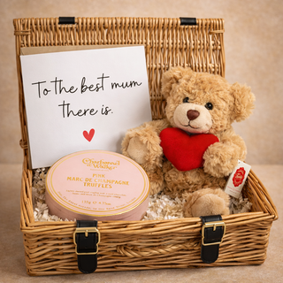 Gift basket with teddy bear, truffles, and card on a beige background - Pangolins