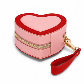 Stackers Heart Travel Jewellery Box in pink and red faux leather with gold zip fastening and wrist strap, designed for storing jewellery at home or while travelling.