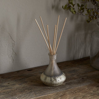Nkuku eco-friendly reed diffuser with sea salt and moss fragrance styled in a natural home setting