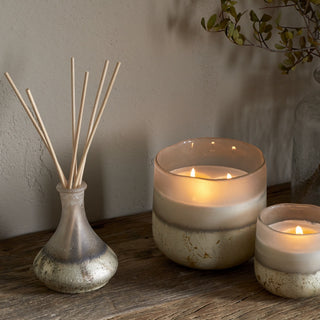 Nkuku eco-friendly reed diffuser with sea salt and moss scent styled with matching candles in a natural home setting