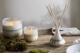 Nkuku eco-friendly reed diffuser with sea salt and moss fragrance styled with candles in a calming home setting