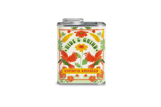 Metal tin of coffee beans with floral design and text on a white background