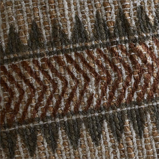 A close-up of a woven textile with a geometric pattern in brown, beige, and gray.