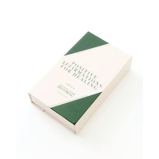A cream-colored box titled 'Positive Affirmations for Healing' by 'So You're Becoming', featuring a minimalist green and cream geometric cover design, photographed on a clean white background.