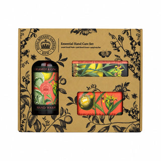 A boxed hand care set from Rose Organic Gardens in Kent, featuring a brown kraft gift box with black botanical illustrations, a dark bottle labeled Mamot & Gins Hand Wash, and two orange-red packaged items visible through cutouts.