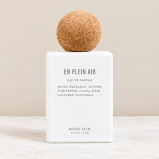 White bottle of perfume with round cork top Norfolk Natural living en plain air