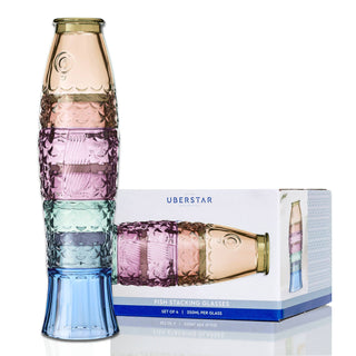A set of four embossed  glasses in pastel colors (gold, pink, mint, and light blue) shown next to their white and blue Uberstar retail packaging box.