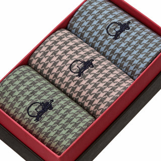 Close-up of pastel houndstooth socks showing fine knit texture in blue, pink and green tones