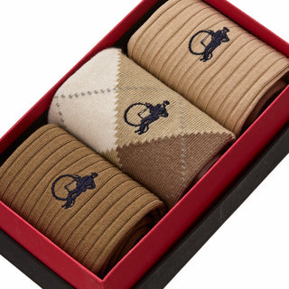 Close-up of London Sock Company argyle socks in sand tones showing diamond pattern and knit texture
