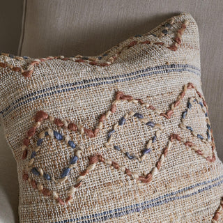 Hand-embroidered detail on Nkuku Nila Esha cushion cover in rust and indigo tones
