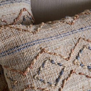 Close-up of Nkuku Nila Esha cushion cover showing cotton and jute woven texture with embroidery