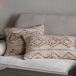Nkuku Nila Esha cushion covers styled on a neutral sofa with cotton and jute embroidered texture